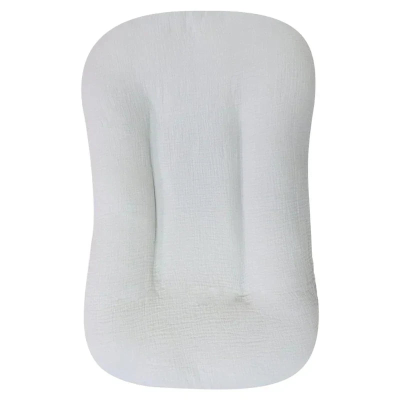 Close-up of the soft, breathable fabric & secure side walls of the baby lounger infant nest.