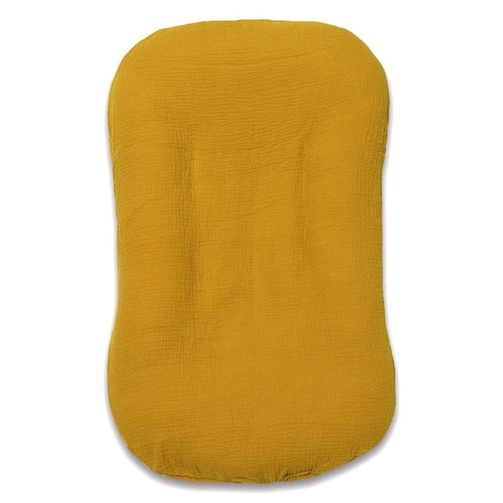 Adorable baby sleeping soundly in a cozy, safe baby lounger, a must-have for newborn sleep.