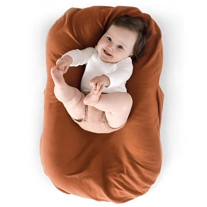 Plush baby lounger designed for maximum baby comfort & peaceful, cozy naps in a soft infant nest.