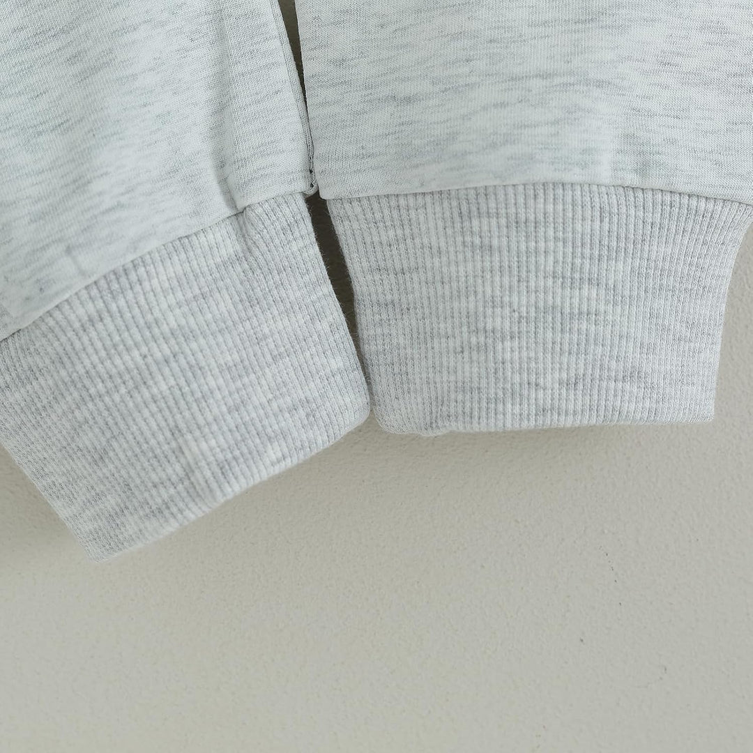 Close-up of baby jogger set, contrast fabric details, ideal for winter.