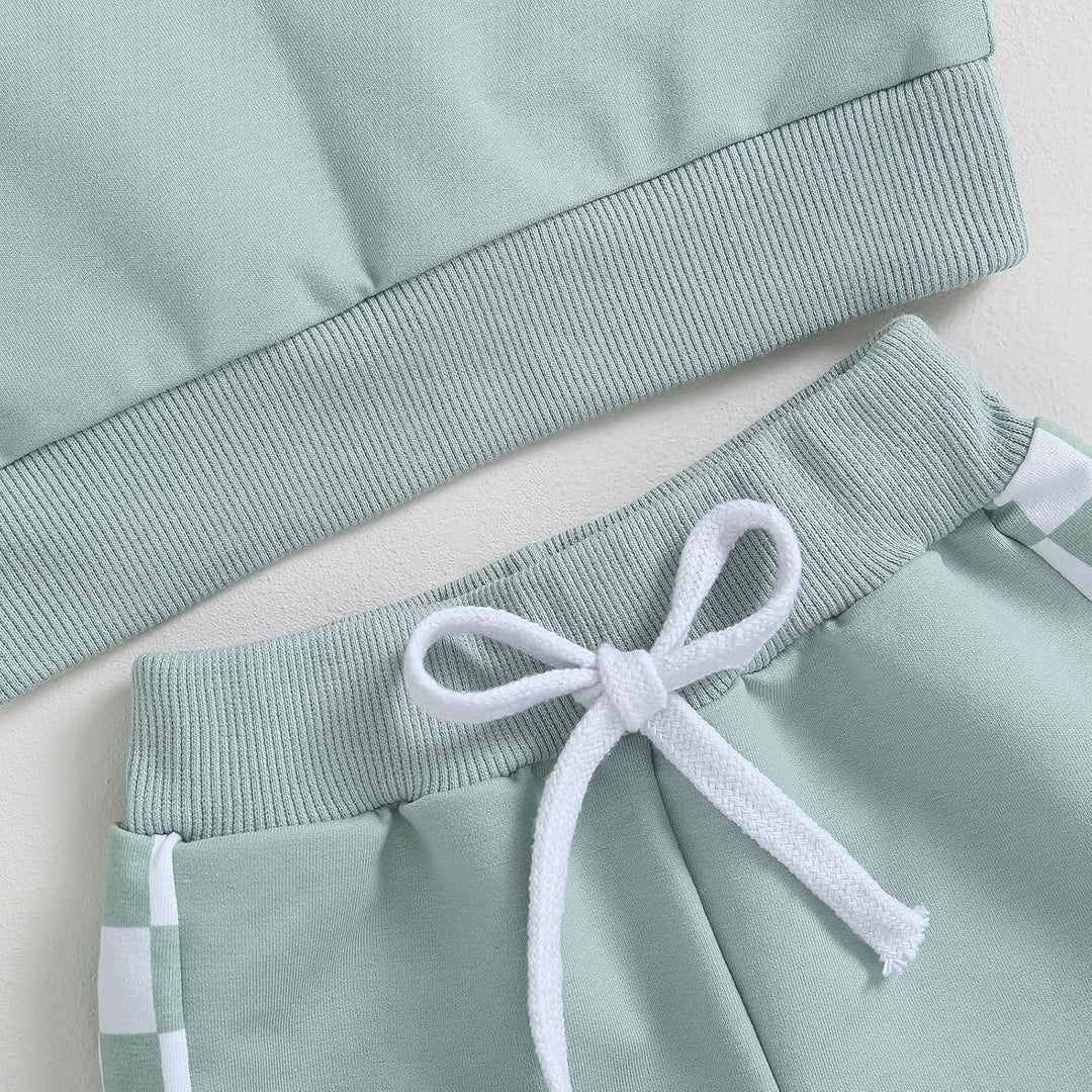 Baby jogger set, close-up of contrast sweatshirt, intricate stitching for quality.