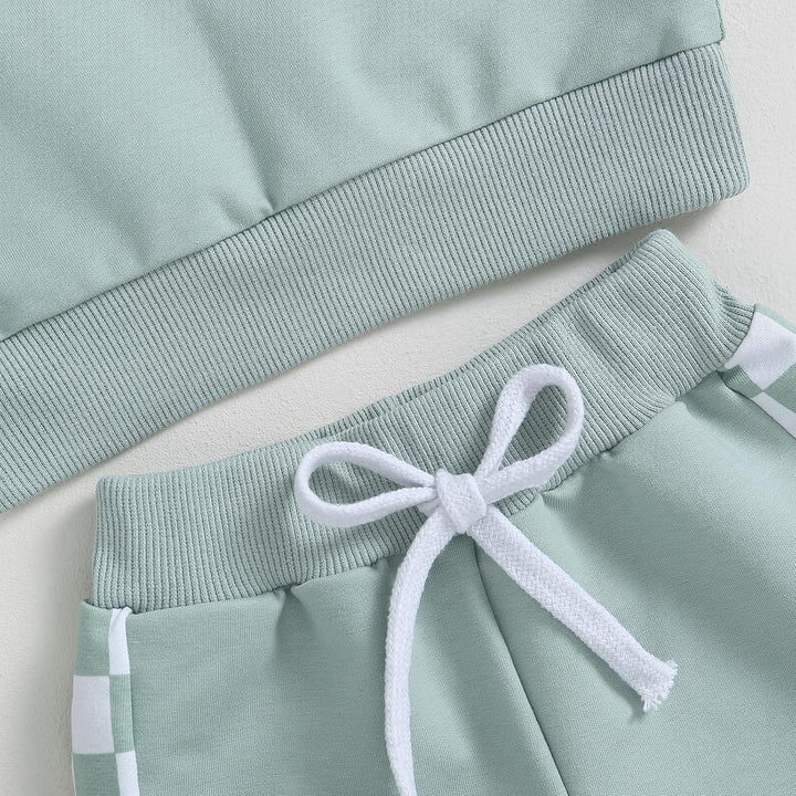 Baby jogger set, close-up of contrast sweatshirt, intricate stitching for quality.