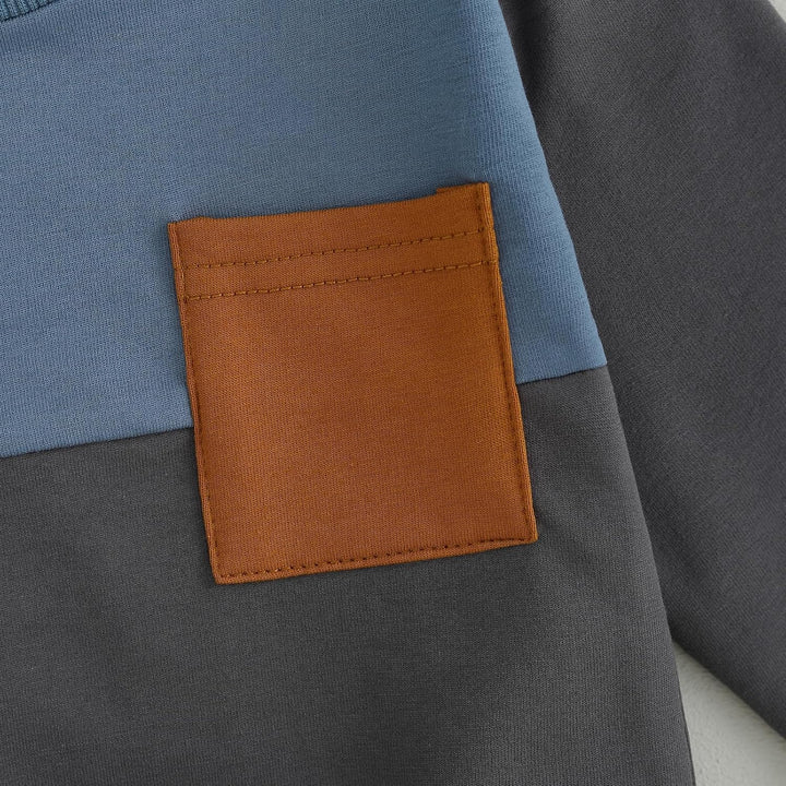 Detail shot of baby jogger set trousers, contrast elements, elastic waist for comfort.
