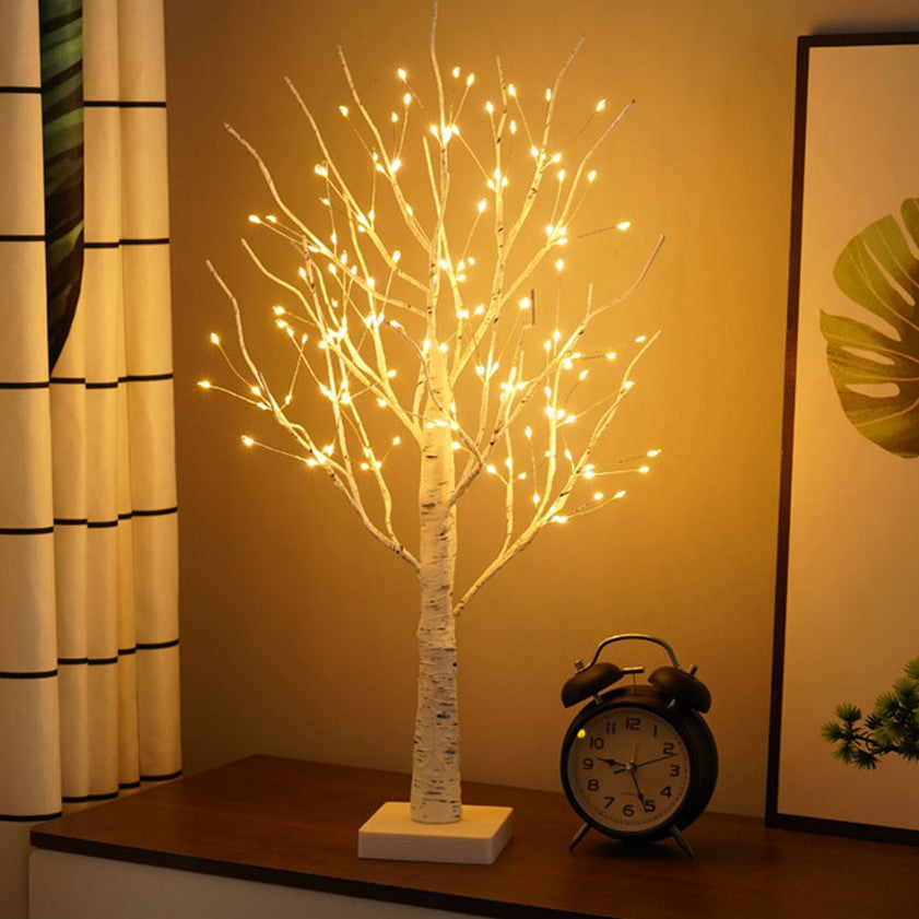 Close-up of flexible branches on an LED birch tree lamp, providing warm accent lighting