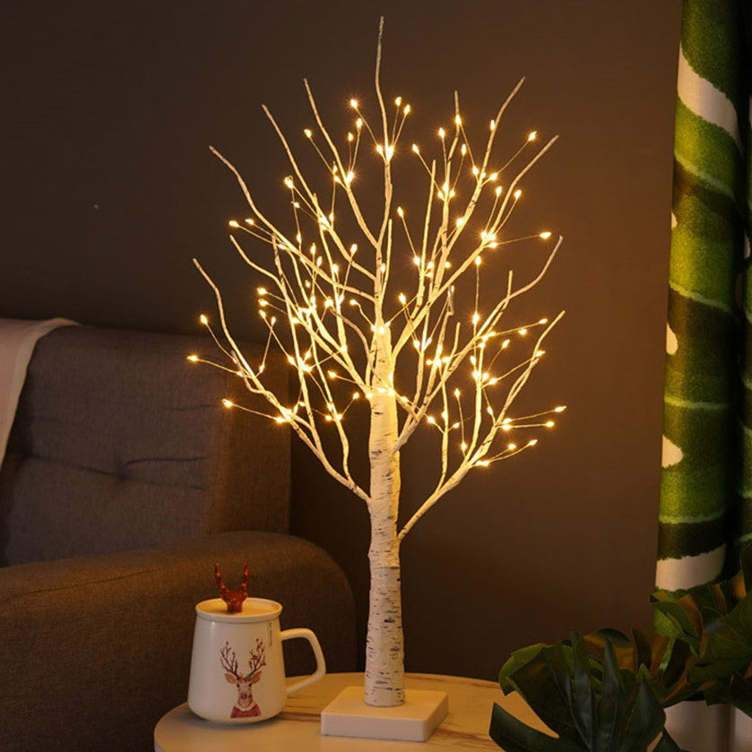 Scandinavian birch tree lamp with multiple LED lights, creating a cozy and warm lighting ambiance