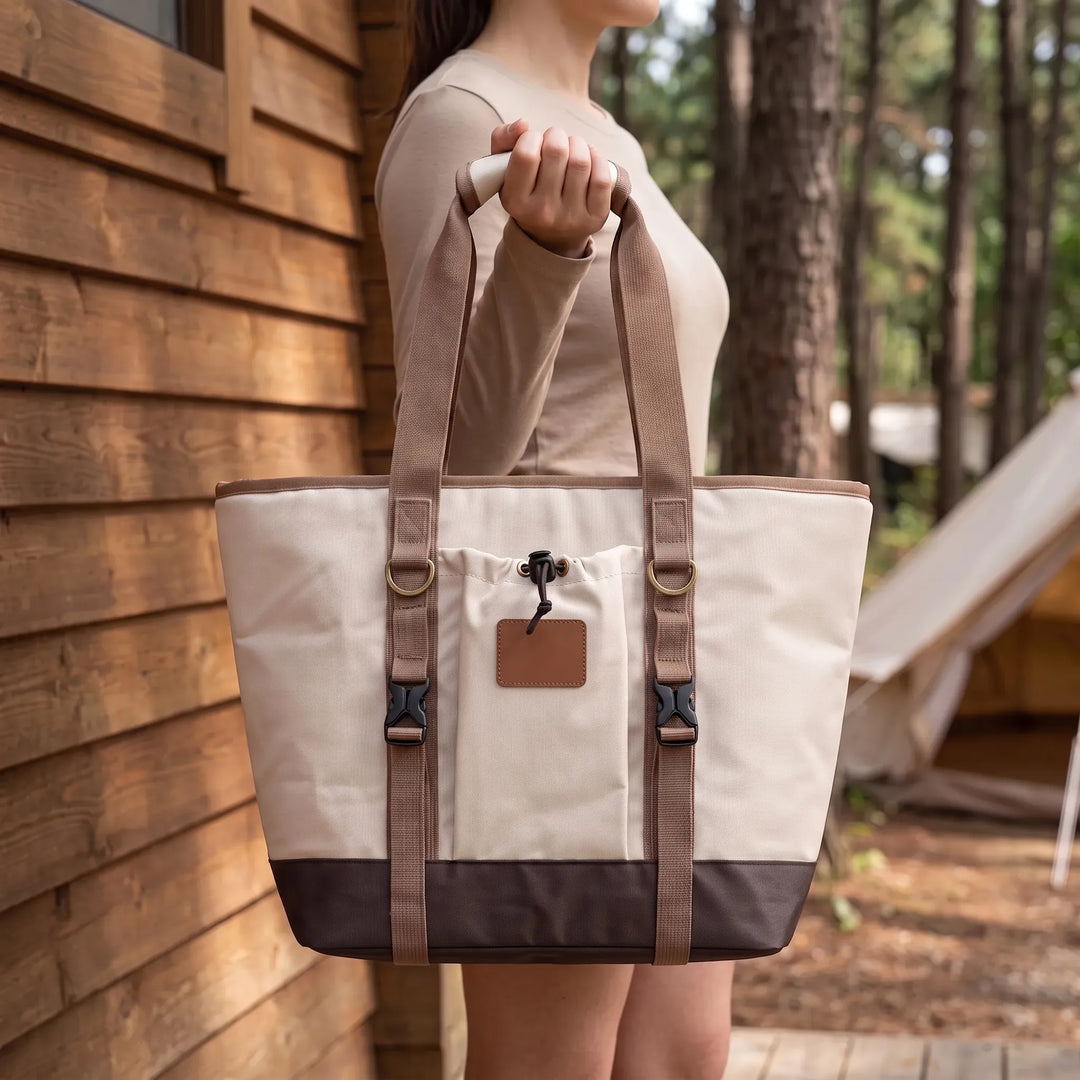 Beige portable insulated soft cooler bag for picnics, camping, and outdoor travel. Perfect food storage.