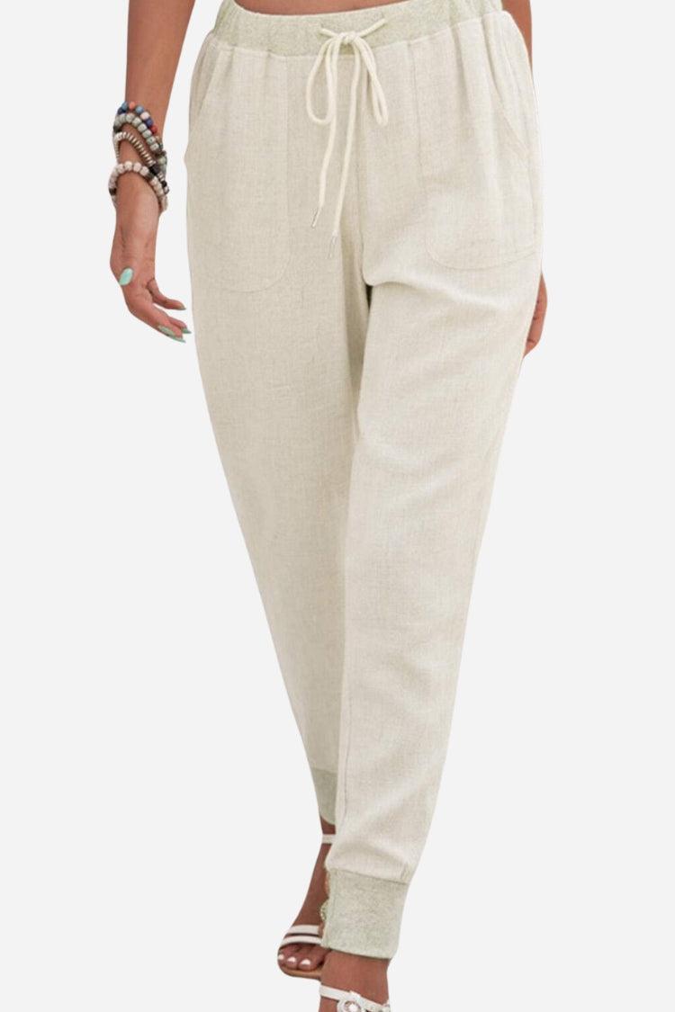 Beige women's comfortable jogger trousers with drawstring waist & tapered leg, perfect for casual everyday wear.