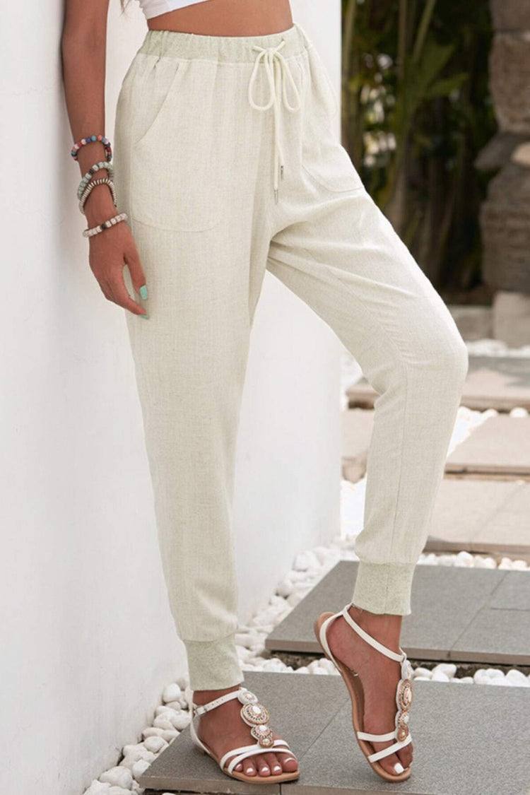 Women's sporty jogger trousers, designed for comfort with a relaxed fit, drawstring waist, and tapered leg.