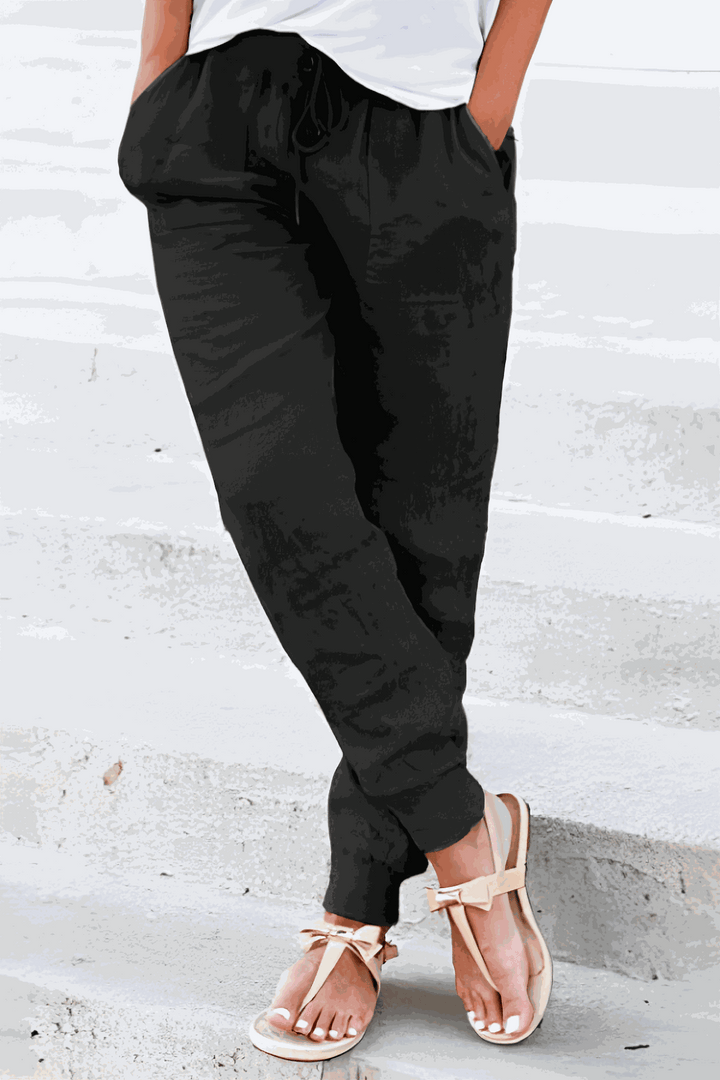 Black women's loungewear joggers, featuring an elastic drawstring waist for ultimate comfort & a sporty look.
