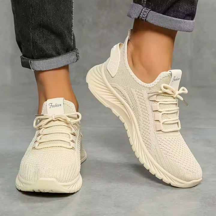 White women's comfort walking shoes, lace-up design with arch support for active lifestyles.