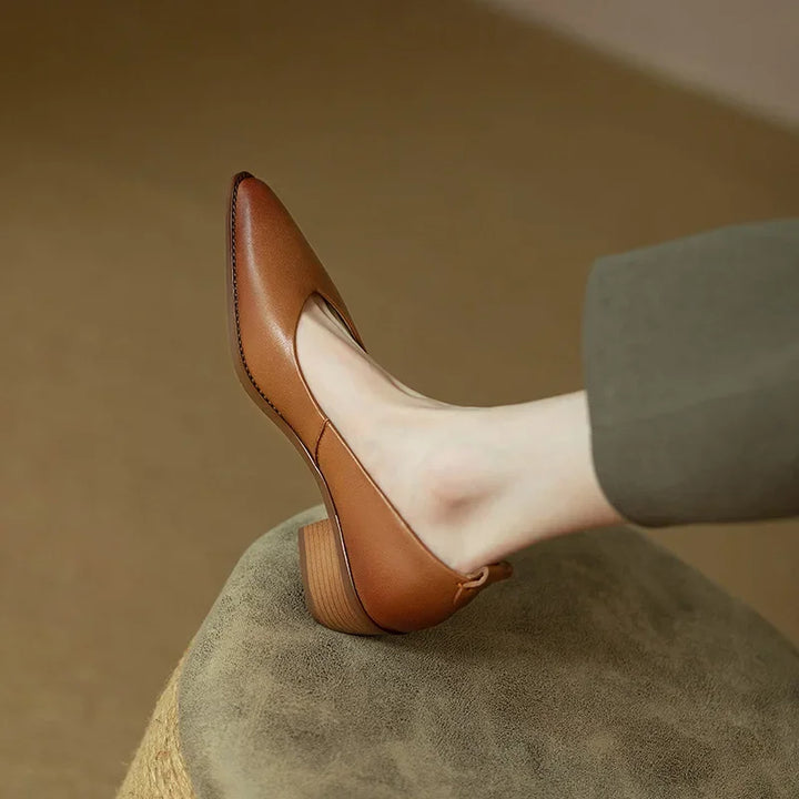 Versatile women's beige slip-on block heel court shoes complementing professional trousers.