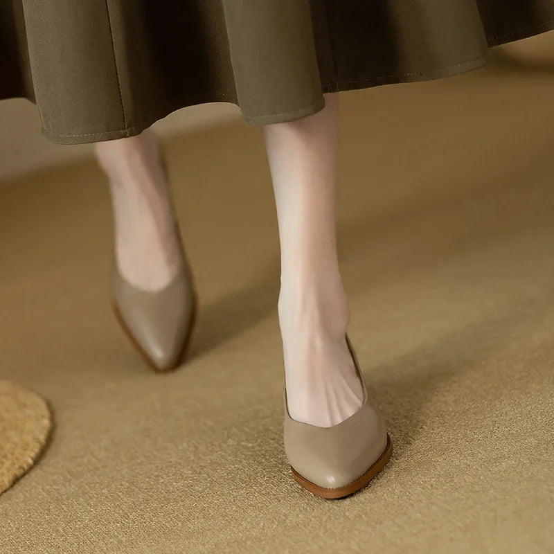 Women's beige pointed toe slip-on shoes with a comfortable block heel, perfect for the office.