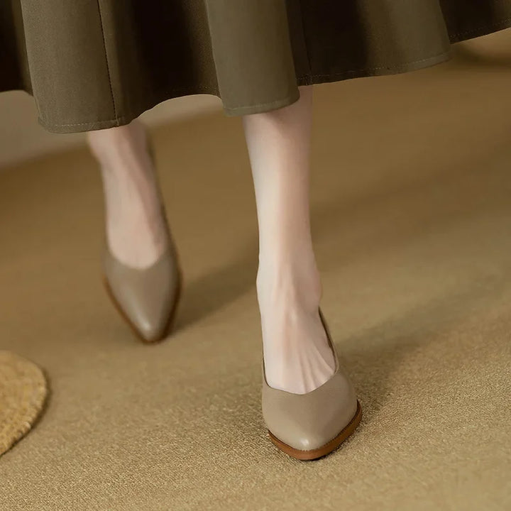 Women's beige pointed toe slip-on shoes with a comfortable block heel, perfect for the office.