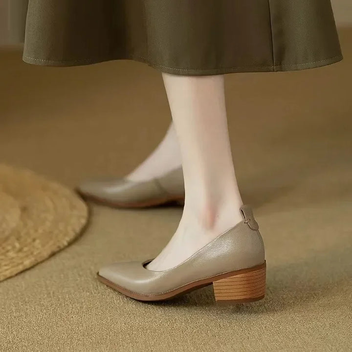 Stylish pointed toe design on beige women's slip-on court heels, a modern elegant look.