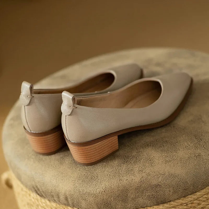 Sturdy block heel on women's beige slip-on court shoes, offering stability and comfort.