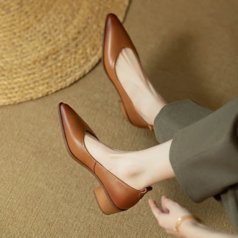 Woman wearing versatile beige pointed toe slip-on block heel court shoes for work.