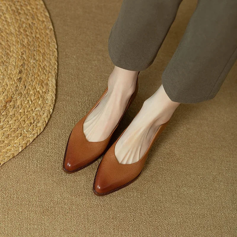 Chic beige pointed toe block heel court shoes completing a woman's workwear outfit.