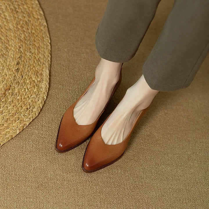 Chic beige pointed toe block heel court shoes completing a woman's workwear outfit.