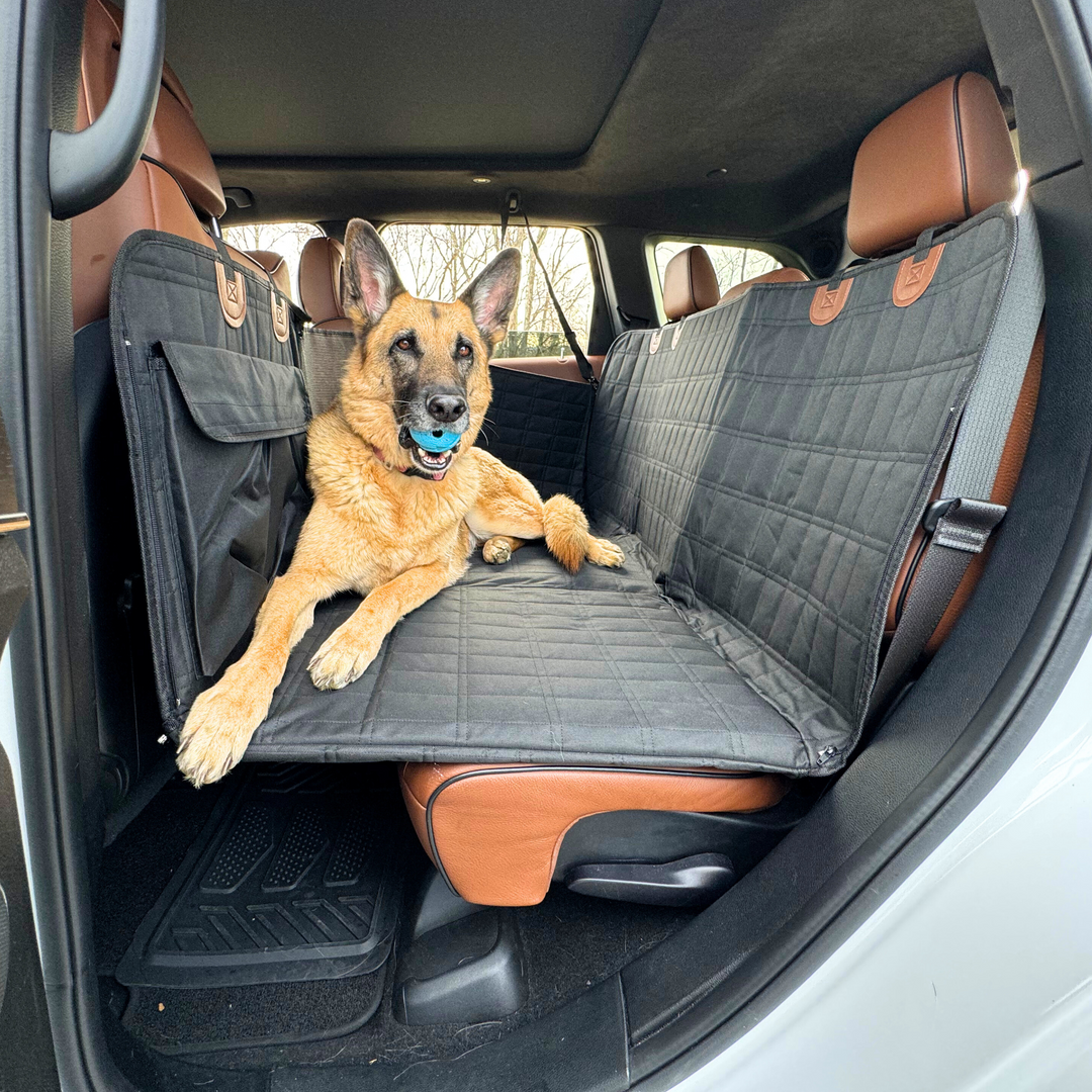 Black dog car backseat extender with door covers for pet travel & car protection.