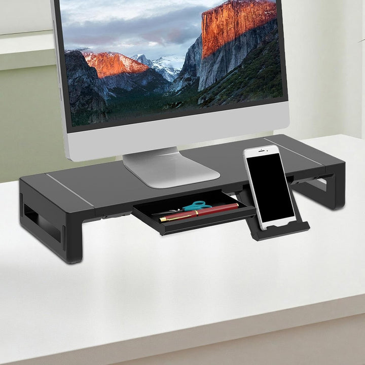 Stravon height adjustable monitor stand in black with a convenient pull-out drawer