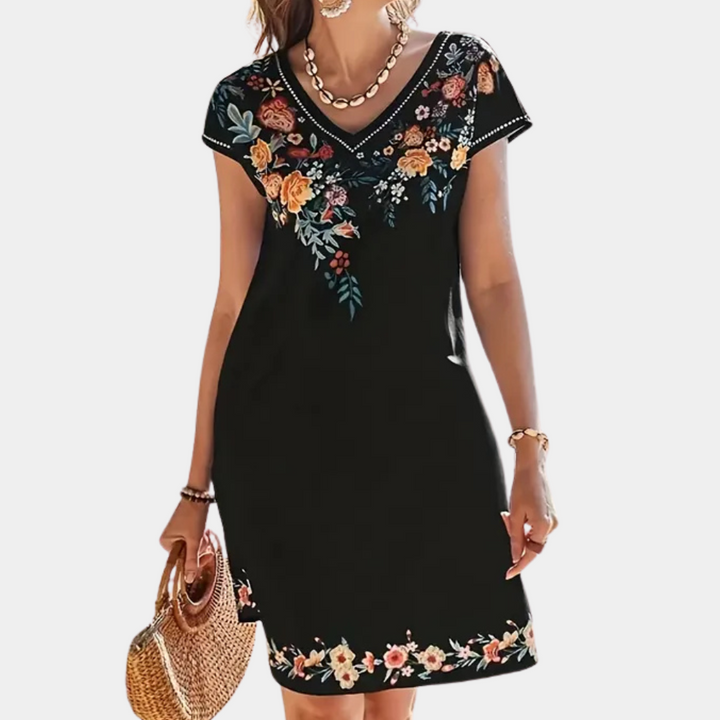 Women's short black floral summer dress. Flowy design, great for casual parties, trendy vacation wear.