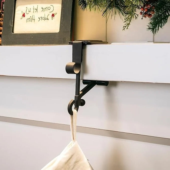 Festive black & gold Christmas stocking & garland holders for stylish mantle decor.