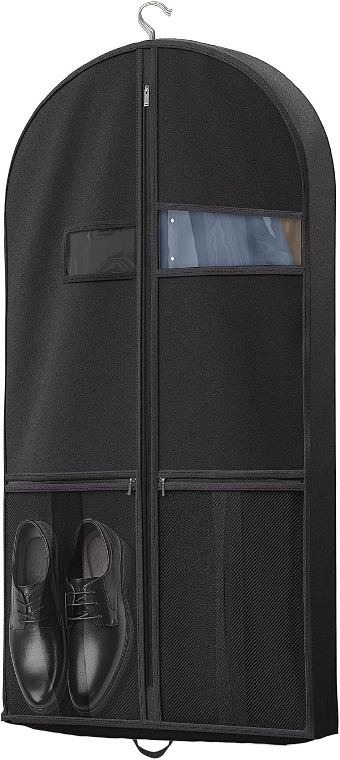 Black garment bag standing upright, demonstrating its stability when full