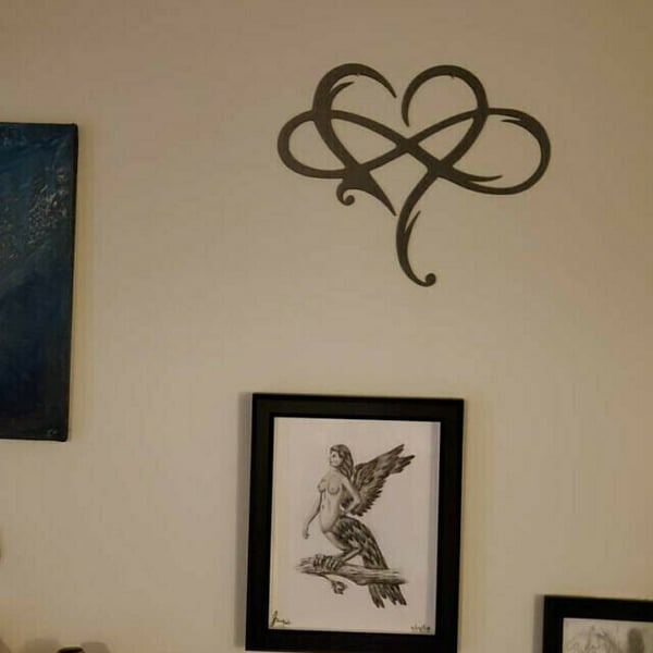 Modern black metal Infinity Heart wall decor, an elegant interior accent for contemporary homes & offices.