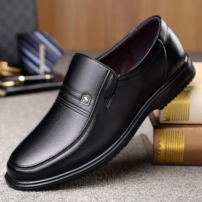 Close-up of elegant black leather slip-on dress shoe texture, showcasing sophisticated men's formal and office footwear.