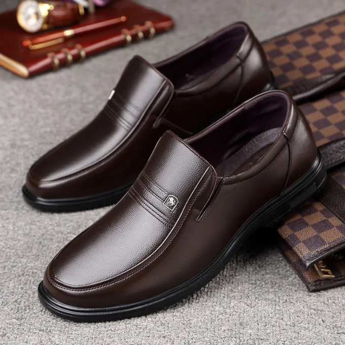 A pair of sophisticated black men's slip-on dress shoes, styled for elegant formal & professional fashion footwear.
