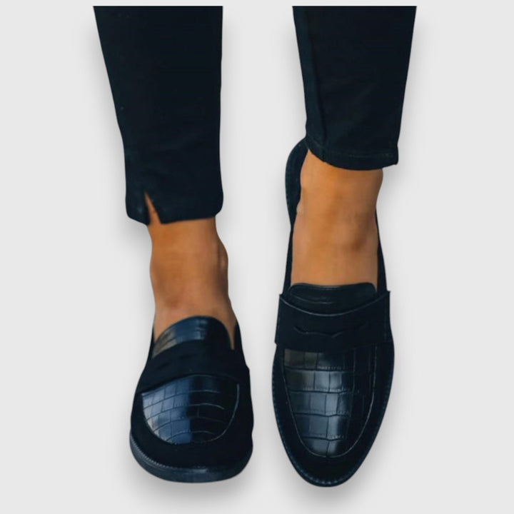 Classic black men's slip-on loafers, combining comfort with versatile style for everyday dress.