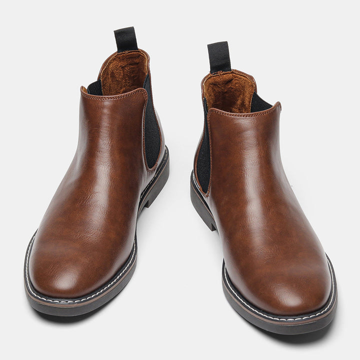 Close-up of black Men's Wyndham Chelsea Boots, showcasing sleek design & quality craftsmanship.