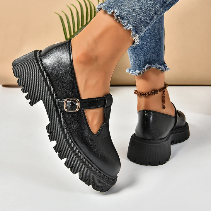 Retro-style black platform Mary Jane shoes for women, featuring a T-strap design and supportive orthopedic sole.