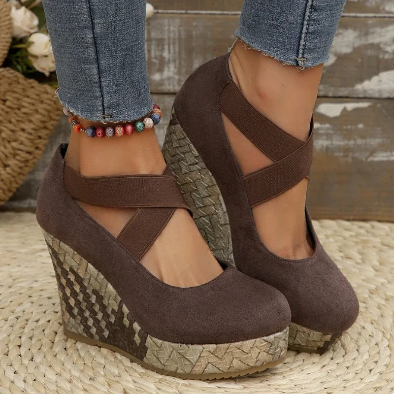 Comfortable women's crisscross wedge sandals in black, providing all-day support and stable footing.