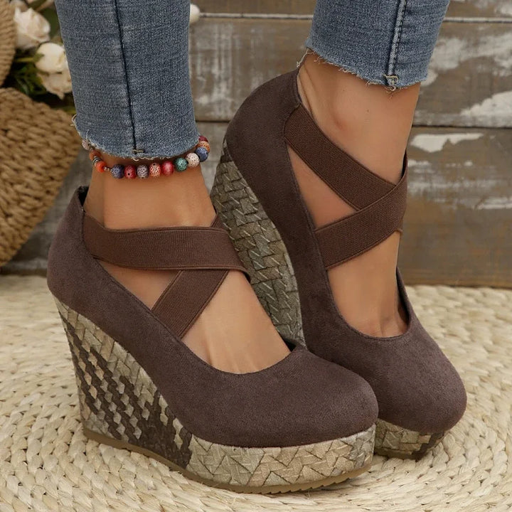 Comfortable women's crisscross wedge sandals in black, providing all-day support and stable footing.