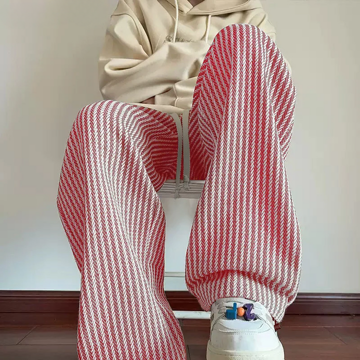Fashionable pink wide-leg sweatpants for women with a unique herringbone pattern, comfy & chic.