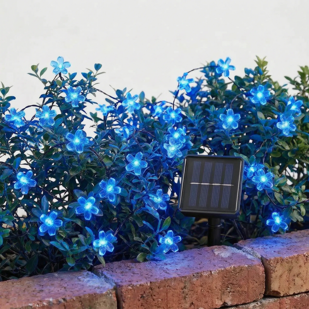 Blossom solar string lights hung on a deck railing, providing soft LED outdoor lighting and garden decor.