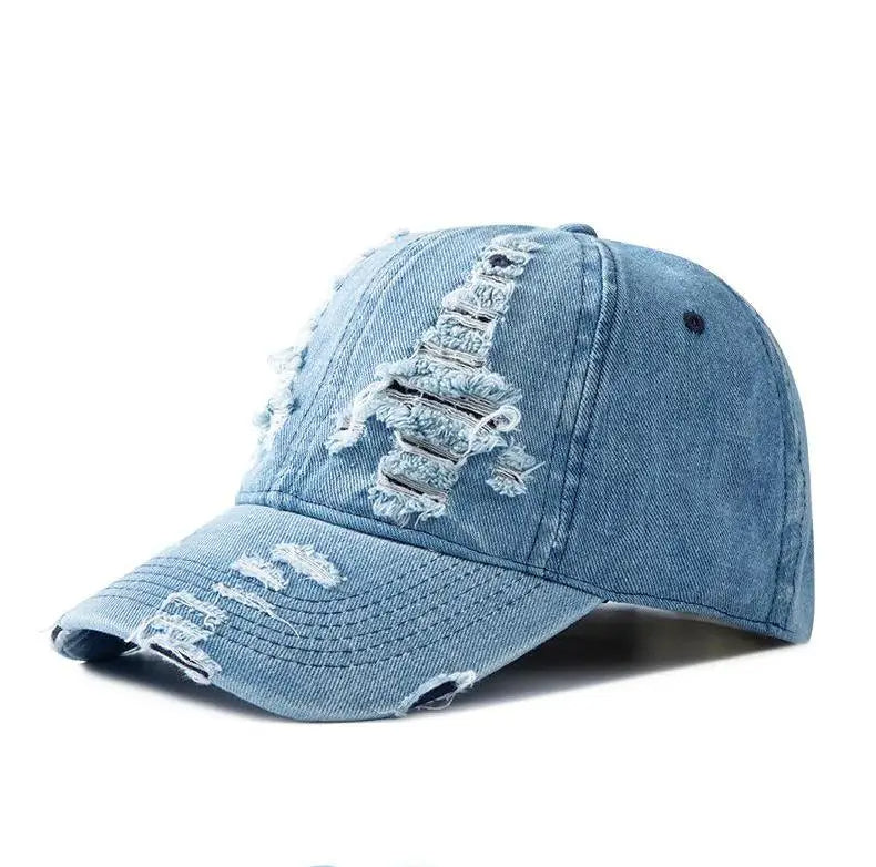 Unisex sun-faded denim cap with a distressed look & raw edge, offering an adjustable, casual streetwear style.