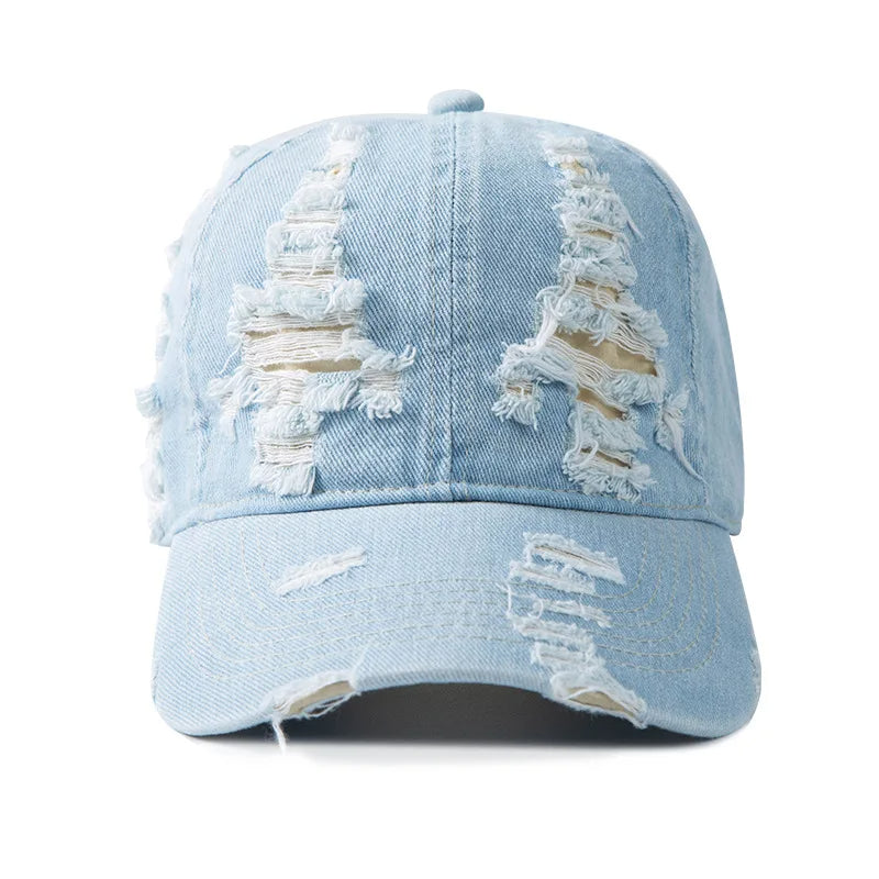 Adjustable unisex distressed denim cap in blue. Features a trendy raw edge for a casual, sun-faded look.
