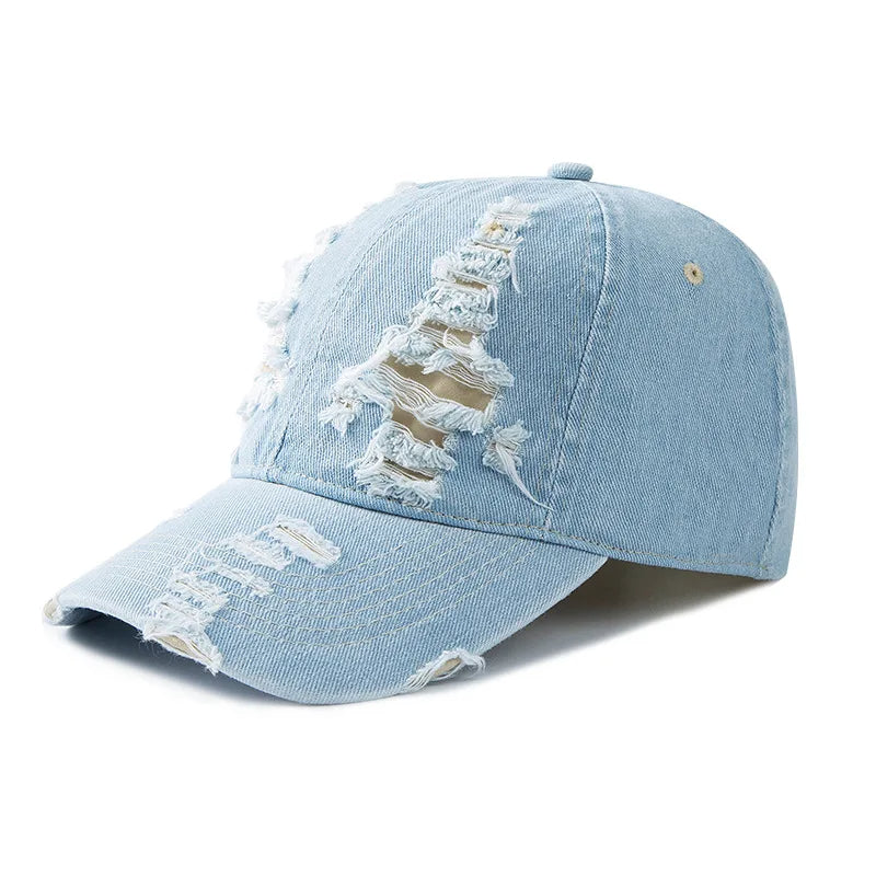 Stylishly distressed blue denim cap with a raw edge brim, adjustable for a comfortable, unisex casual accessory.