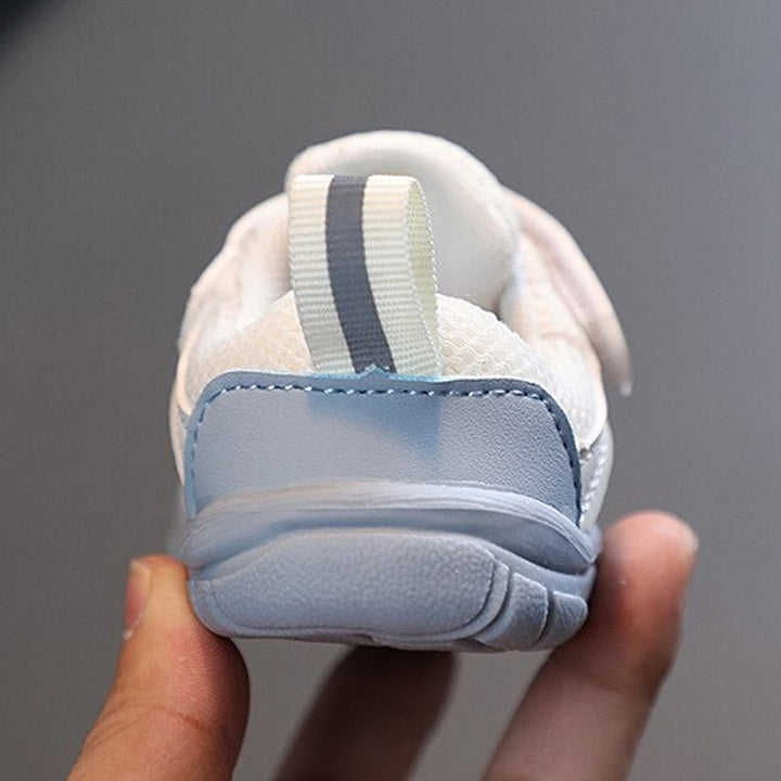 Stack of blue & beige FlexiToes baby barefoot sneakers, comfortable for healthy foot development.