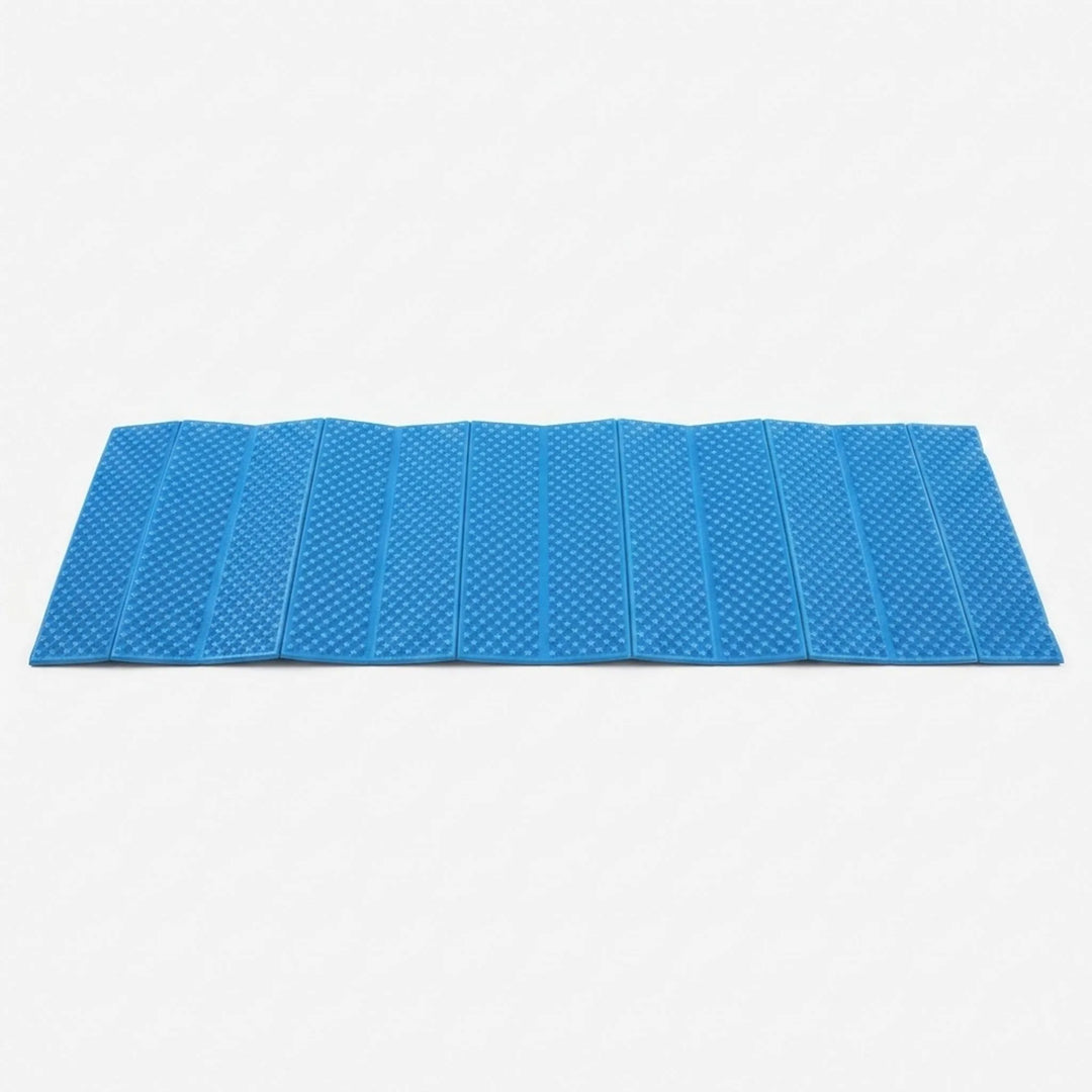 Blue closed-cell sleeping pad, foldable for comfortable outdoor camping.