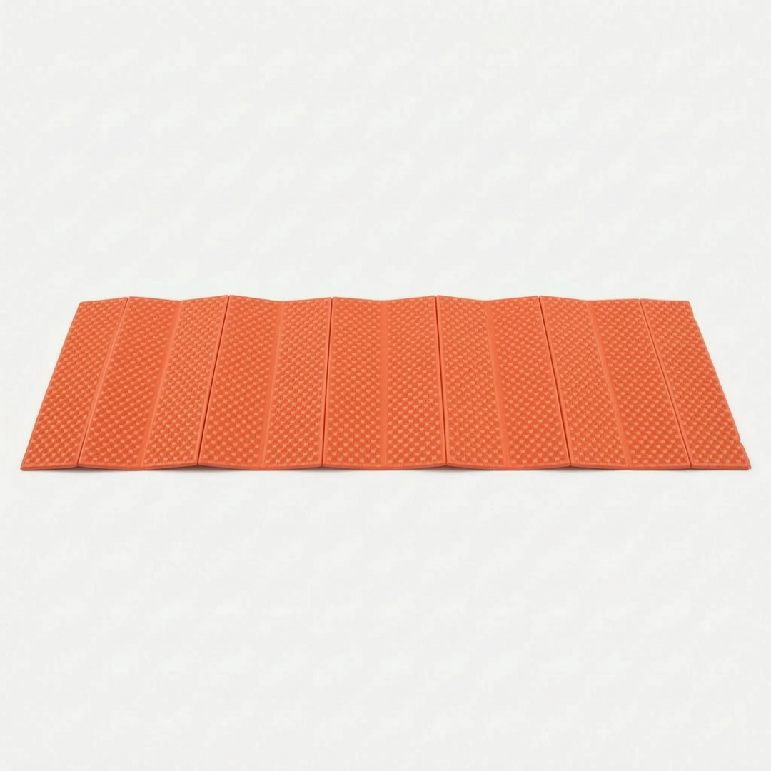 Compact blue camping mat, closed-cell and foldable for travel and outdoor recreation.