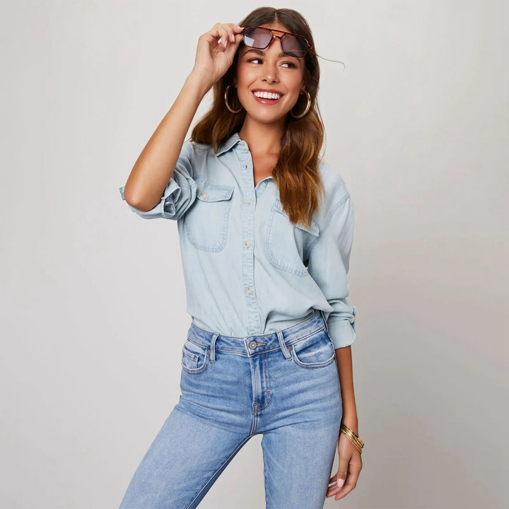 Classic women's blue button-up shirt, long sleeve, with a relaxed fit for comfortable and stylish everyday wear.