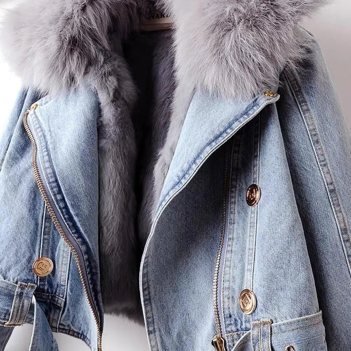 Warm blue women's winter jacket with chic faux fur trim, essential stylish outerwear for cold seasons.