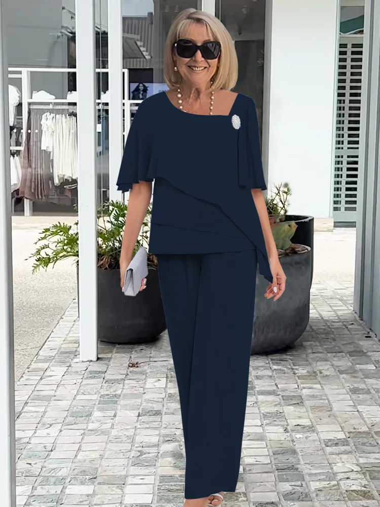 Coordinated women's overlay top and straight-leg pants set in blue. Casual chic two-piece outfit for elegant wear.