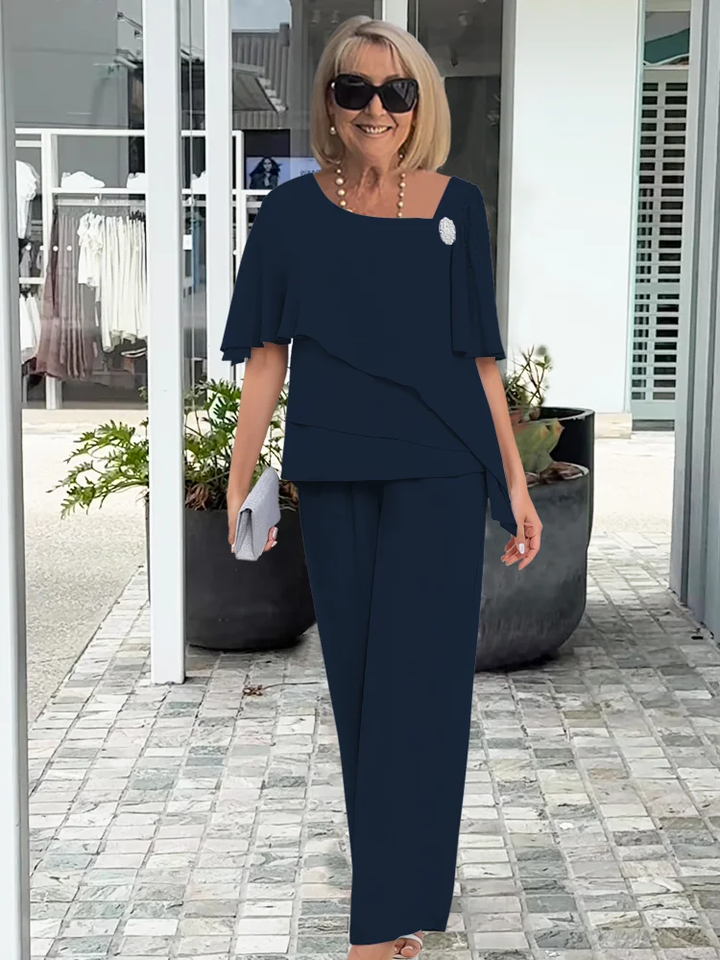 Coordinated women's overlay top and straight-leg pants set in blue. Casual chic two-piece outfit for elegant wear.