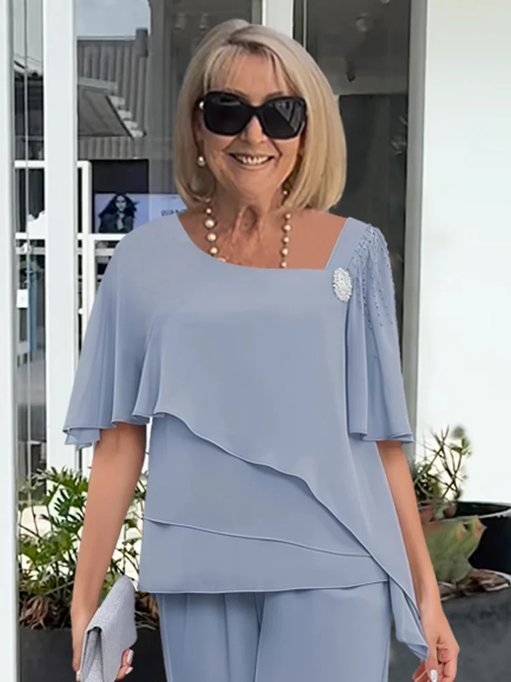 Stylish blue women's matching set: elegant overlay top & straight-leg pants. Sophisticated & versatile two-piece outfit.