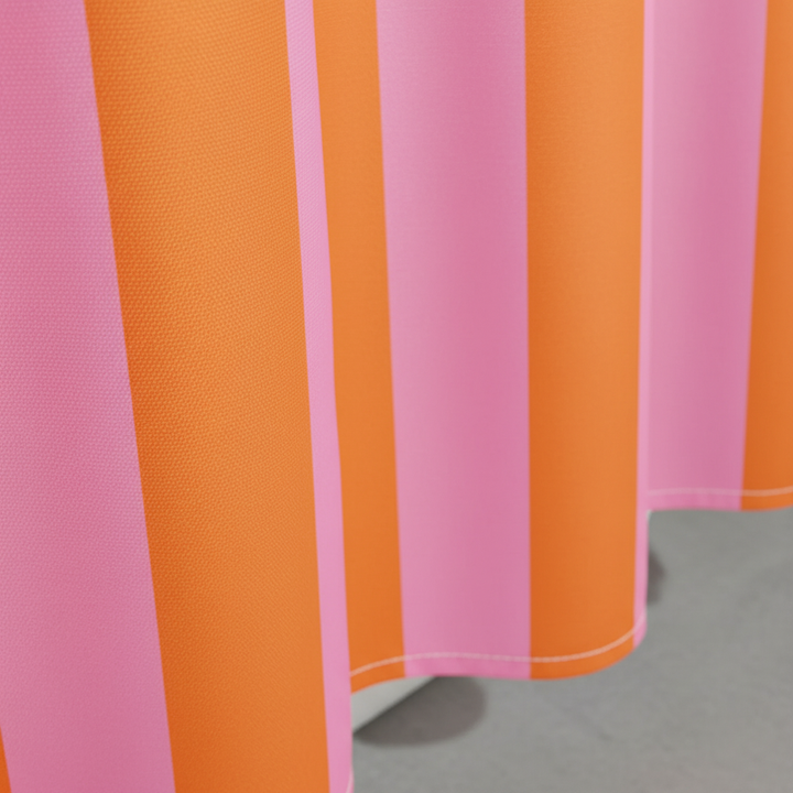 Close-up of the textured fabric of a boho striped shower curtain in neutral tones, showing quality