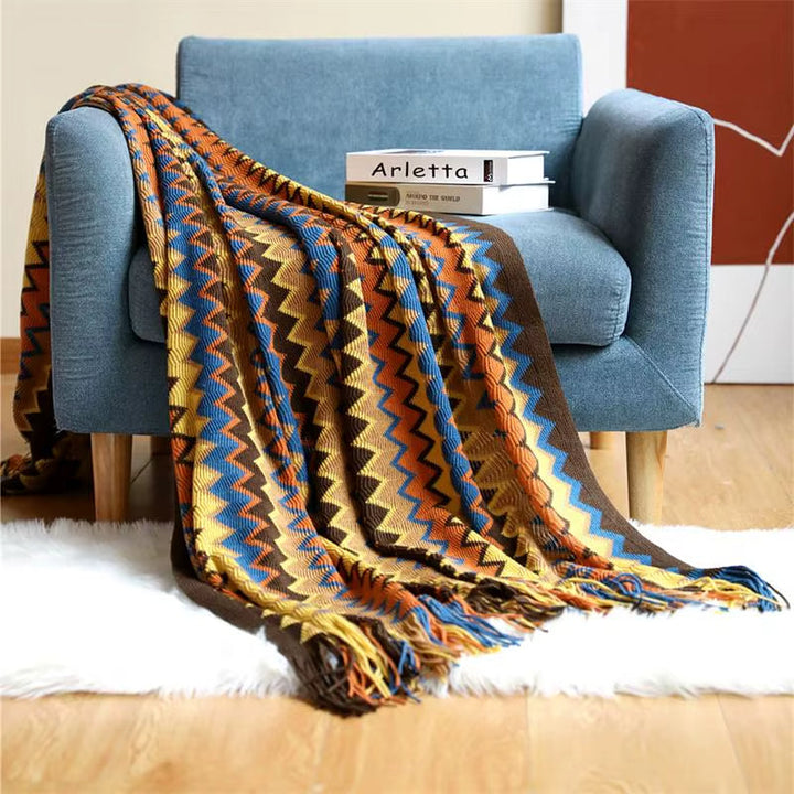 Boho striped throw blanket with tassels, perfect for cozy home decor and living room accent.